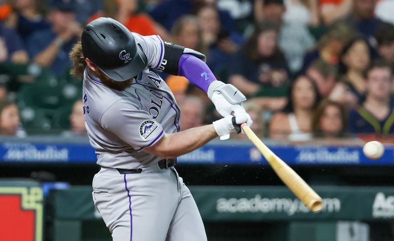 Jun 25, 2024; Houston, Texas, USA; Colorado Rockies second baseman Brendan Rodgers (7) hits a single against the Houston Astros in the fourth inning at Minute Maid Park. Mandatory Credit: Thomas Shea-USA TODAY Sports