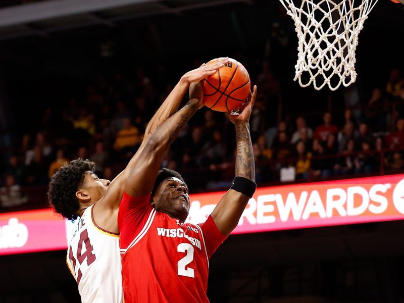 Jan 23, 2024; Minneapolis, Minnesota, USA; Minnesota Golden Gophers guard Cam Christie (24) blocks a shot by Wisconsin Badgers guard AJ Storr (2) during the second half at Williams Arena. Mandatory Credit: Matt Krohn-USA TODAY Sports