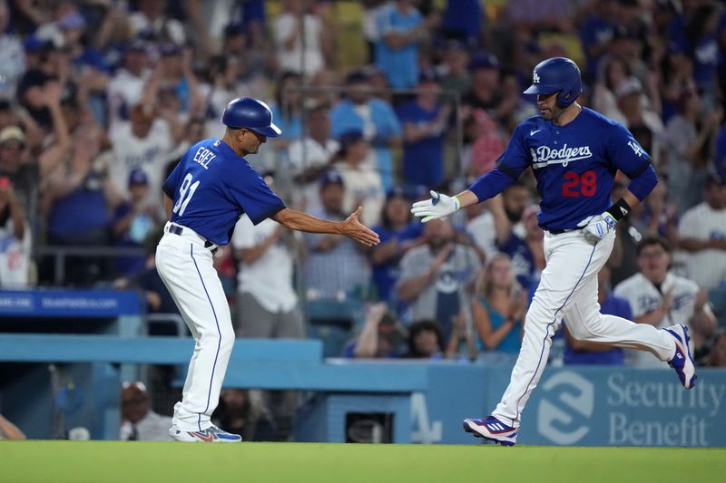 Jul 25, 2023; Los Angeles, California, USA; Los Angeles Dodgers designated hitter J.D. Martinez (28) is greeted by third base coach Dino Ebel (91) after hitting a home run in the eighth inning against the Toronto Blue Jays at Dodger Stadium. Mandatory Credit: Kirby Lee-USA TODAY Sports