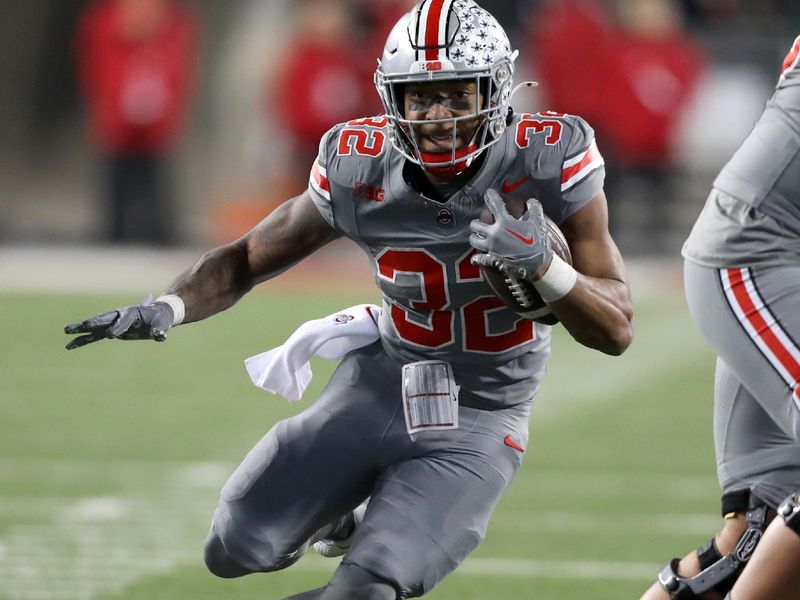 Nov 11, 2023; Columbus, Ohio, USA; Ohio State Buckeyes running back TreVeyon Henderson (32) runs the ball during the second quarter against the Michigan State Spartans at Ohio Stadium. Mandatory Credit: Joseph Maiorana-USA TODAY Sports