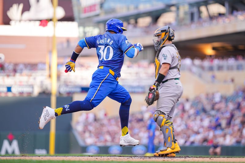 Jun 14, 2024; Minneapolis, Minnesota, USA; Minnesota Twins first base Carlos Santana (30) scores against the Oakland Athletics in the second inning at Target Field. Mandatory Credit: Brad Rempel-USA TODAY Sports