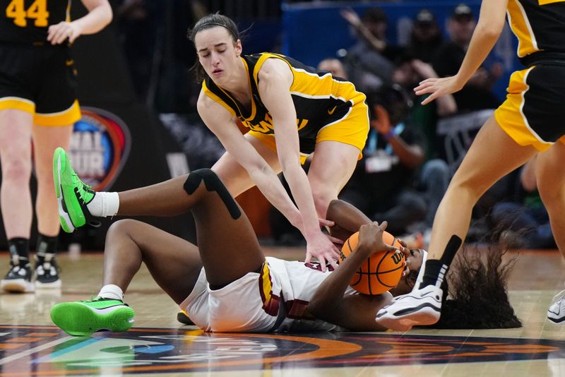 Apr 7, 2024; Cleveland, OH, USA; South Carolina Gamecocks guard Raven Johnson (25) fights for a loose ball against Iowa Hawkeyes guard Caitlin Clark (22) in the second quarter in the finals of the Final Four of the womens 2024 NCAA Tournament at Rocket Mortgage FieldHouse. Mandatory Credit: Kirby Lee-USA TODAY Sports