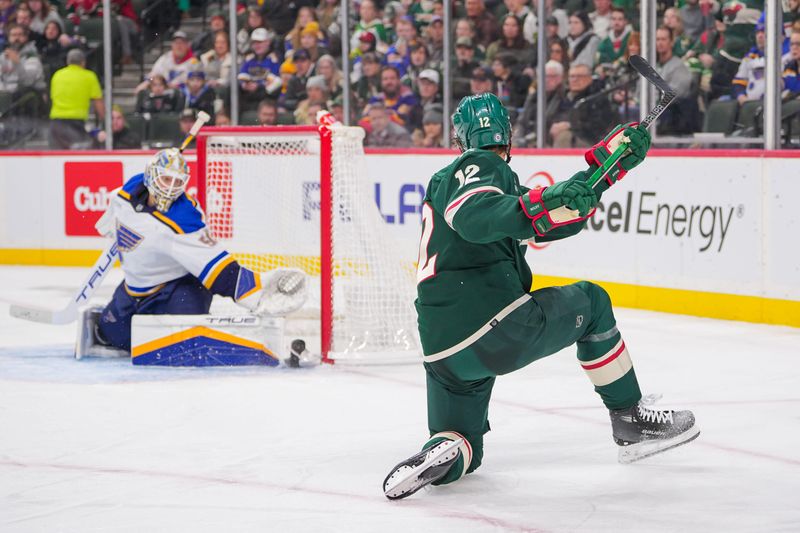 Nov 28, 2023; Saint Paul, Minnesota, USA; Minnesota Wild left wing Matt Boldy (12) shoots against the St. Louis Blues goaltender Jordan Binnington (50) in the second period at Xcel Energy Center. Mandatory Credit: Brad Rempel-USA TODAY Sports