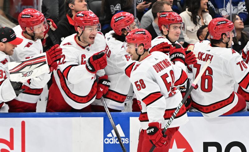 Dec 30, 2023; Toronto, Ontario, CAN; Carolina Hurricanes forward Michael Bunting (58) celebrates after scoring a goal against the Toronto Maple Leafs in the first period at Scotiabank Arena. Mandatory Credit: Dan Hamilton-USA TODAY Sports