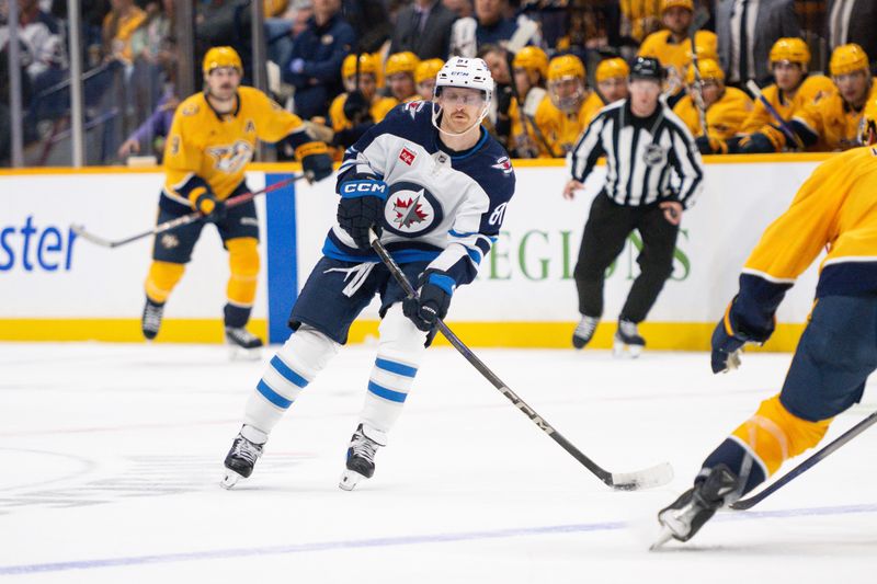 Nov 23, 2024; Nashville, Tennessee, USA;  Winnipeg Jets left wing Kyle Connor (81) skates with the puck against against the Nashville Predators during the second period at Bridgestone Arena. Mandatory Credit: Steve Roberts-Imagn Images