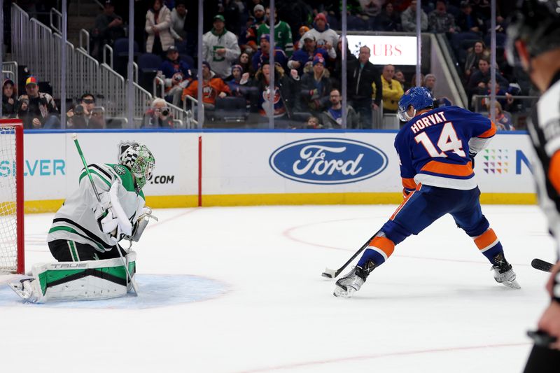 Jan 21, 2024; Elmont, New York, USA; New York Islanders center Bo Horvat (14) scores the game winning goal against Dallas Stars goaltender Scott Wedgewood (41) during overtime at UBS Arena. Mandatory Credit: Brad Penner-USA TODAY Sports