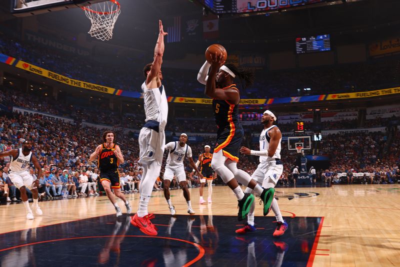 OKLAHOMA CITY, OK - APRIL 14:  Luguentz Dort #5 of the Oklahoma City Thunder looks to pass the ball during the game against the Dallas Mavericks on April 14, 2024 at Paycom Arena in Oklahoma City, Oklahoma. NOTE TO USER: User expressly acknowledges and agrees that, by downloading and or using this photograph, User is consenting to the terms and conditions of the Getty Images License Agreement. Mandatory Copyright Notice: Copyright 2024 NBAE (Photo by Zach Beeker/NBAE via Getty Images)