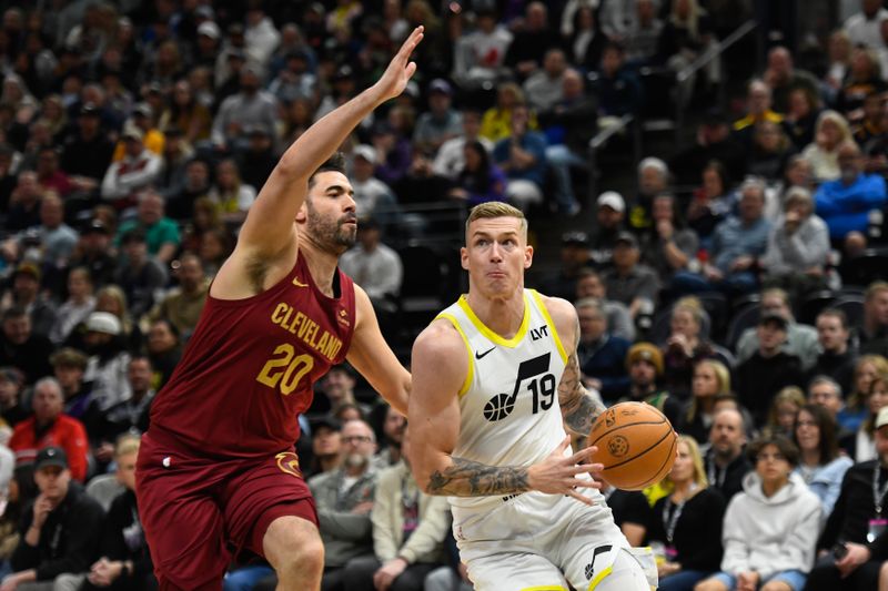 SALT LAKE CITY, UTAH - APRIL 02: Luka Samanic #19 of the Utah Jazz drives into Georges Niang #20 of the Cleveland Cavaliers during the first half of a game at Delta Center on April 02, 2024 in Salt Lake City, Utah. NOTE TO USER: User expressly acknowledges and agrees that, by downloading and or using this photograph, User is consenting to the terms and conditions of the Getty Images License Agreement. (Photo by Alex Goodlett/Getty Images)