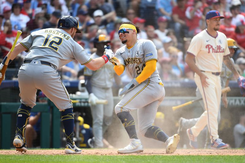 Jun 1, 2025; Philadelphia, Pennsylvania, USA; Milwaukee Brewers catcher William Contreras (24) celebrates after scoring run with first base Rhys Hoskins (12) during the seventh inning against the Philadelphia Phillies at Citizens Bank Park. Mandatory Credit: Eric Hartline-Imagn Images