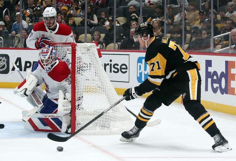 Nov 2, 2024; Pittsburgh, Pennsylvania, USA;  Montreal Canadiens goaltender Sam Montembeault (35) defends the net against Pittsburgh Penguins center Evgeni Malkin (71) during the third period at PPG Paints Arena. Mandatory Credit: Charles LeClaire-Imagn Images