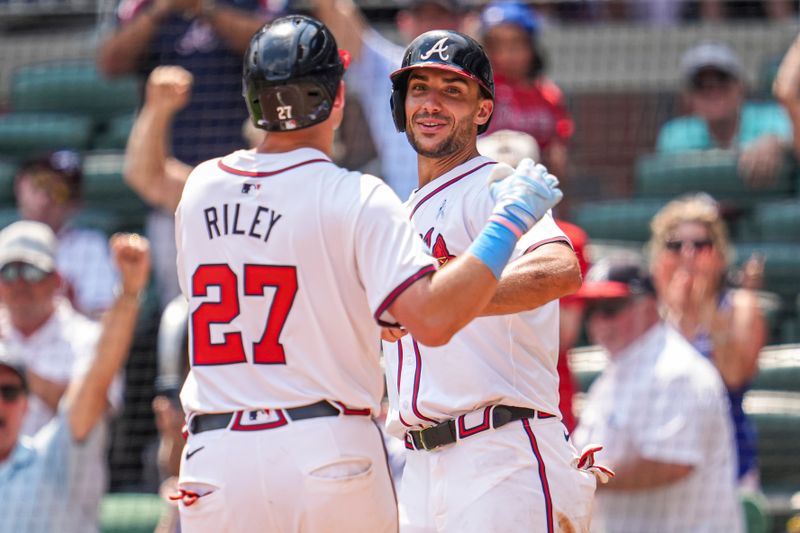 Jun 16, 2024; Cumberland, Georgia, USA; Atlanta Braves third baseman Austin Riley (27) reacts with first baseman Matt Olson (28) after hitting a game tying two run home run against the Tampa Bay Rays during the eighth inning at Truist Park. Mandatory Credit: Dale Zanine-USA TODAY Sports