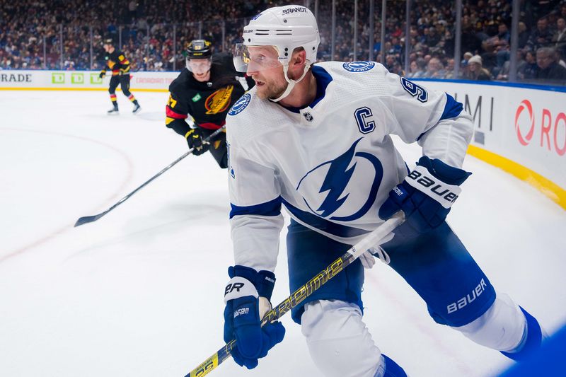 Dec 12, 2023; Vancouver, British Columbia, CAN; Tampa Bay Lightning forward Steven Stamkos (91) handles the puck against the Vancouver Canucks in the third period at Rogers Arena. Vancouver won 4-1. Mandatory Credit: Bob Frid-USA TODAY Sports