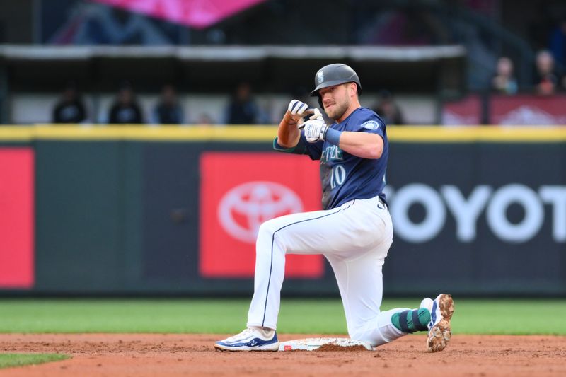 Jun 11, 2024; Seattle, Washington, USA; Seattle Mariners first baseman Luke Raley (20) celebrates after hitting a double against the Chicago White Sox during the second inning at T-Mobile Park. Mandatory Credit: Steven Bisig-USA TODAY Sports