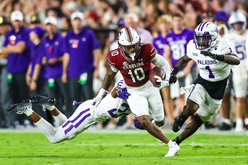 Sep 9, 2023; Columbia, South Carolina, USA; South Carolina Gamecocks wide receiver Ahmarean Brown (10) is brought down by Furman Paladins cornerback Ivan Yates (22) during the first quarter at Williams-Brice Stadium. Mandatory Credit: Jeff Blake-USA TODAY Sports