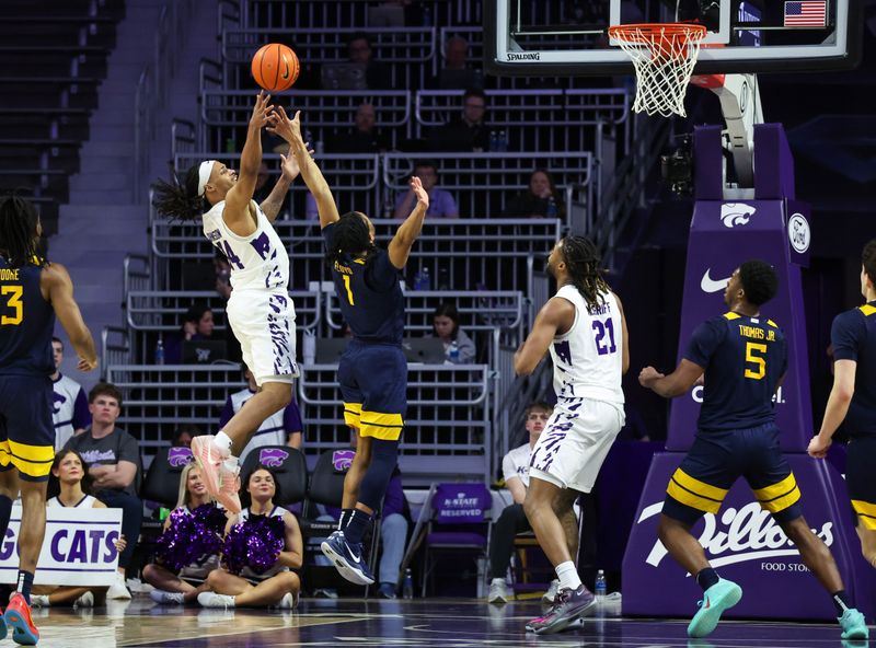 Mar 3, 2026; Manhattan, Kansas, USA; Kansas State Wildcats guard Nate Johnson (34) shoots against West Virginia Mountaineers guard Jasper Floyd (1) during the first half at Bramlage Coliseum. Mandatory Credit: Scott Sewell-Imagn Images