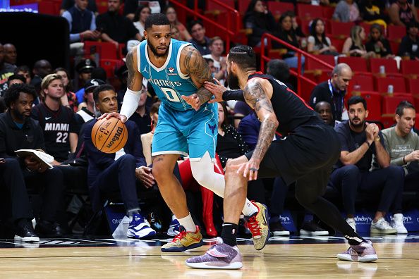 MIAMI, FLORIDA - DECEMBER 13: Miles Bridges #0 of the Charlotte Hornets drives against Caleb Martin #16 of the Miami Heat during the fourth quarter of the game at Kaseya Center on December 13, 2023 in Miami, Florida. NOTE TO USER: User expressly acknowledges and agrees that, by downloading and or using this photograph, User is consenting to the terms and conditions of the Getty Images License Agreement. (Photo by Megan Briggs/Getty Images)