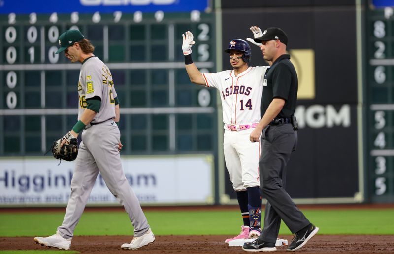 May 27, 2025; Houston, Texas, USA; Houston Astros second baseman Mauricio Dubon (14) reacts to his RBI double against the Athletics in the second inning at Daikin Park. Mandatory Credit: Thomas Shea-Imagn Images