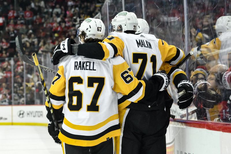 Apr 2, 2024; Newark, New Jersey, USA; Pittsburgh Penguins center Evgeni Malkin (71) celebrates with teammates after scoring a goal against the New Jersey Devils during the third period at Prudential Center. Mandatory Credit: John Jones-USA TODAY Sports