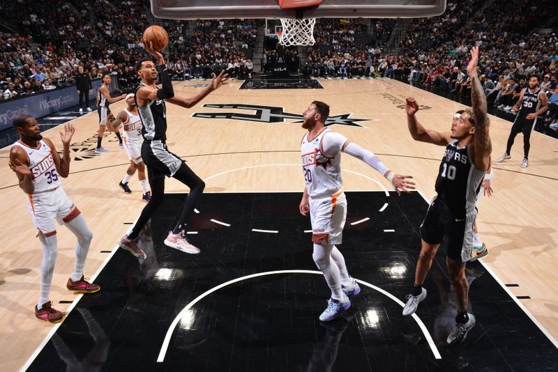 SAN ANTONIO, TX - MARCH 23: Victor Wembanyama #1 of the San Antonio Spurs drives to the basket during the game against the Phoenix Suns on March 23, 2024 at the Frost Bank Center in San Antonio, Texas. NOTE TO USER: User expressly acknowledges and agrees that, by downloading and or using this photograph, user is consenting to the terms and conditions of the Getty Images License Agreement. Mandatory Copyright Notice: Copyright 2024 NBAE (Photos by Jesse D. Garrabrant/NBAE via Getty Images)