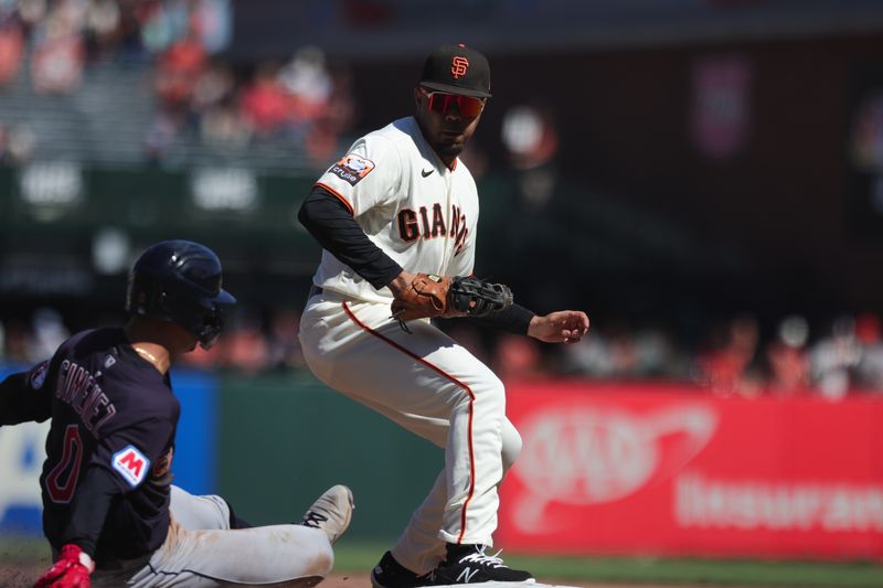 Sep 13, 2023; San Francisco, California, USA; San Francisco Giants first baseman LaMonte Wade Jr. (31) steps on first base for an out during the eighth inning against the Cleveland Guardians at Oracle Park. Mandatory Credit: Sergio Estrada-USA TODAY Sports