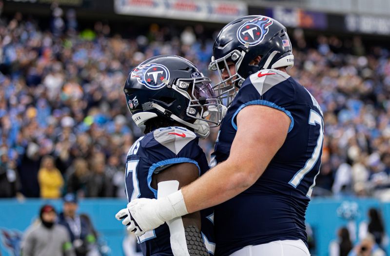 Tennessee Titans running back Tyjae Spears, left, is congratulated by offensive tackle Dillon Radunz (75) after scoring a touchdown during their NFL football game against the Jacksonville Jaguars Sunday, Jan. 7, 2024, in Nashville, Tenn. (AP Photo/Wade Payne)