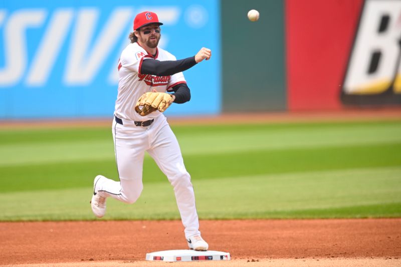 Jun 1, 2025; Cleveland, Ohio, USA; Cleveland Guardians second baseman Daniel Schneemann (10) turns a double play in the first inning against the Los Angeles Angels at Progressive Field. Mandatory Credit: David Richard-Imagn Images