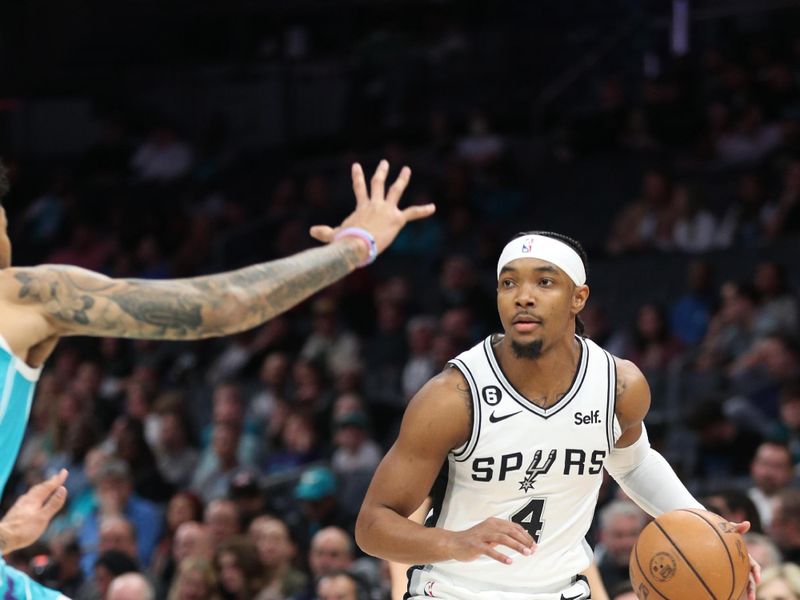 CHARLOTTE, NC - FEBRUARY 15: Devonte' Graham #4 of the San Antonio Spurs handles the ball during the game against the Charlotte Hornets on February 15, 2023 at Spectrum Center in Charlotte, North Carolina. NOTE TO USER: User expressly acknowledges and agrees that, by downloading and or using this photograph, User is consenting to the terms and conditions of the Getty Images License Agreement.  Mandatory Copyright Notice:  Copyright 2023 NBAE (Photo by Brock Williams-Smith/NBAE via Getty Images)