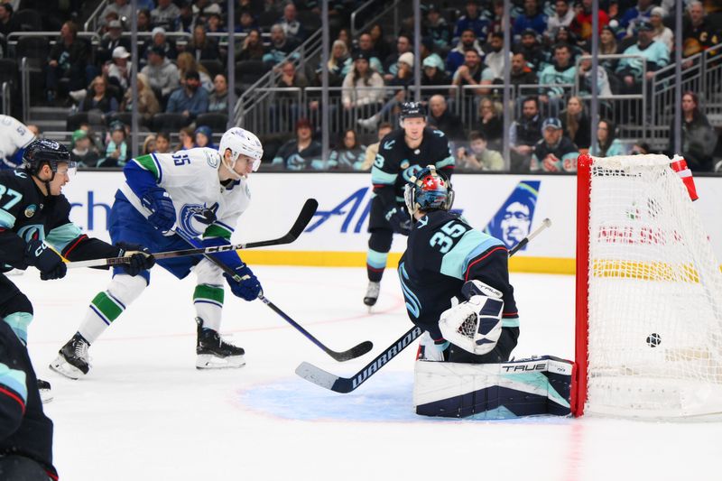 Nov 24, 2023; Seattle, Washington, USA; Vancouver Canucks right wing Ilya Mikheyev (65) scores a goal past Seattle Kraken goaltender Joey Daccord (35) during the third period at Climate Pledge Arena. Mandatory Credit: Steven Bisig-USA TODAY Sports