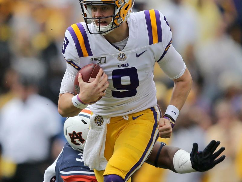 Oct 26, 2019; Baton Rouge, LA, USA; LSU Tigers quarterback Joe Burrow (9) is tackled by Auburn Tigers defensive end Marlon Davidson (3) in the first quarter at Tiger Stadium. Mandatory Credit: Chuck Cook-USA TODAY Sports