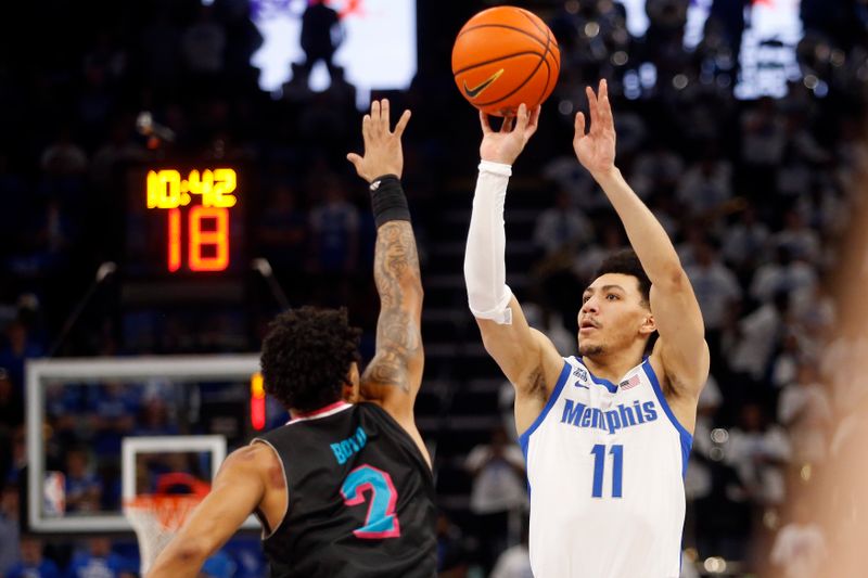 Feb 25, 2024; Memphis, Tennessee, USA; Memphis Tigers guard Jahvon Quinerly (11) shoots for three during the first half against the Florida Atlantic Owls at FedExForum. Mandatory Credit: Petre Thomas-USA TODAY Sports