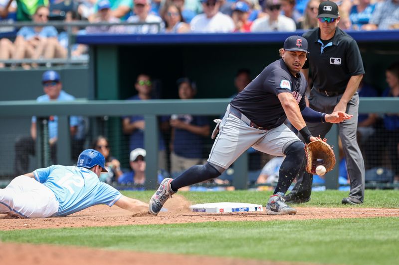 Jun 30, 2024; Kansas City, Missouri, USA; Cleveland Guardians first base Josh Naylor (22) reaches for a throw as Kansas City Royals second base Nick Loftin (12) dives back to first base during the sixth inning at Kauffman Stadium. Mandatory Credit: William Purnell-USA TODAY Sports