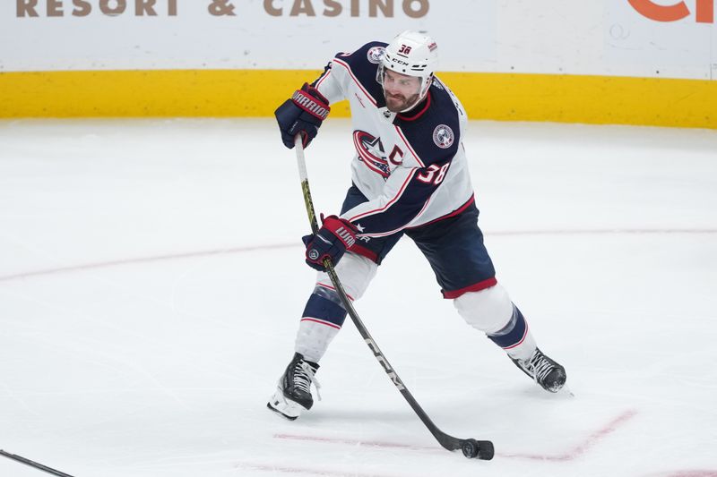 Feb 17, 2024; San Jose, California, USA; Columbus Blue Jackets center Boone Jenner (38) shoots against the San Jose Sharks during the third period at SAP Center at San Jose. Mandatory Credit: Darren Yamashita-USA TODAY Sports