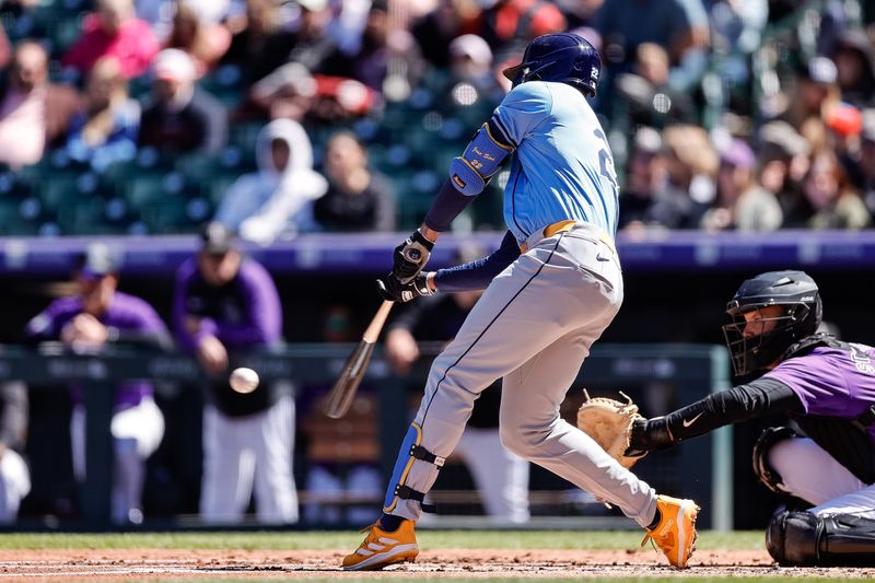 Apr 7, 2024; Denver, Colorado, USA; Tampa Bay Rays center fielder Jose Siri (22) hits an RBI single in the second inning against the Colorado Rockies at Coors Field. Mandatory Credit: Isaiah J. Downing-USA TODAY Sports