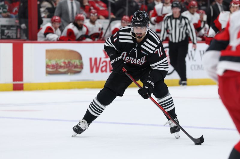 Jan 17, 2026; Newark, New Jersey, USA; New Jersey Devils defenseman Jonas Siegenthaler (71) controls the puck against the Carolina Hurricanes during the second period at Prudential Center. Mandatory Credit: Thomas Salus-Imagn Images
