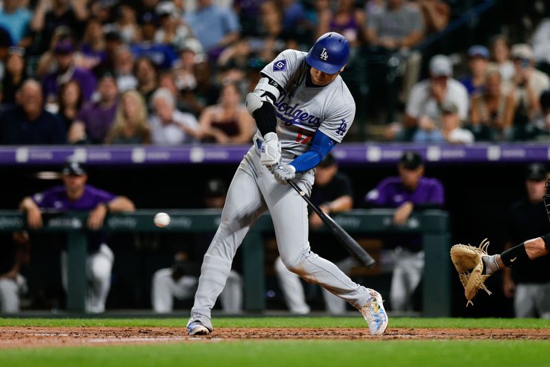 Sep 27, 2024; Denver, Colorado, USA; Los Angeles Dodgers designated hitter Shohei Ohtani (17) hits a single in the fourth inning against the Colorado Rockies at Coors Field. Mandatory Credit: Isaiah J. Downing-Imagn Images