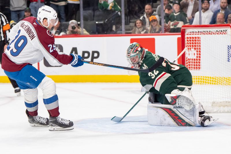 Mar 11, 2025; Saint Paul, Minnesota, USA; Minnesota Wild goaltender Filip Gustavsson (32) makes a save on Colorado Avalanche center Nathan MacKinnon (29) in the shootout at Xcel Energy Center. Mandatory Credit: Matt Blewett-Imagn Images
