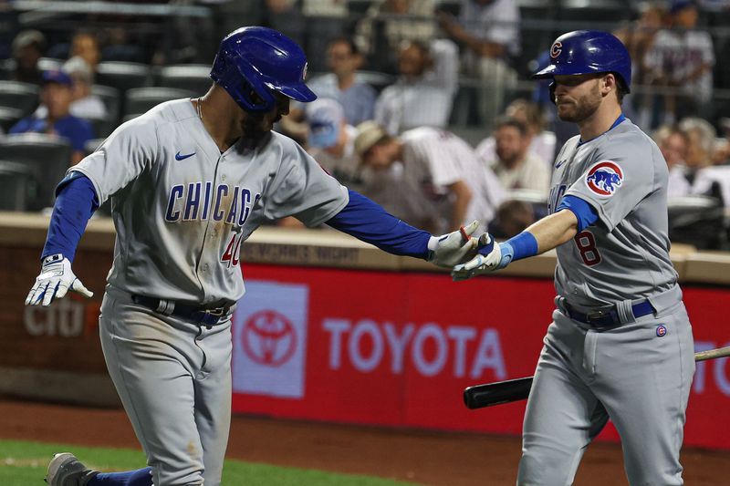 Aug 8, 2023; New York City, New York, USA; Chicago Cubs center fielder Mike Tauchman (40) celebrates with left fielder Ian Happ (8) after his solo home run during the eighth inning against the New York Mets at Citi Field. Mandatory Credit: Vincent Carchietta-USA TODAY Sports