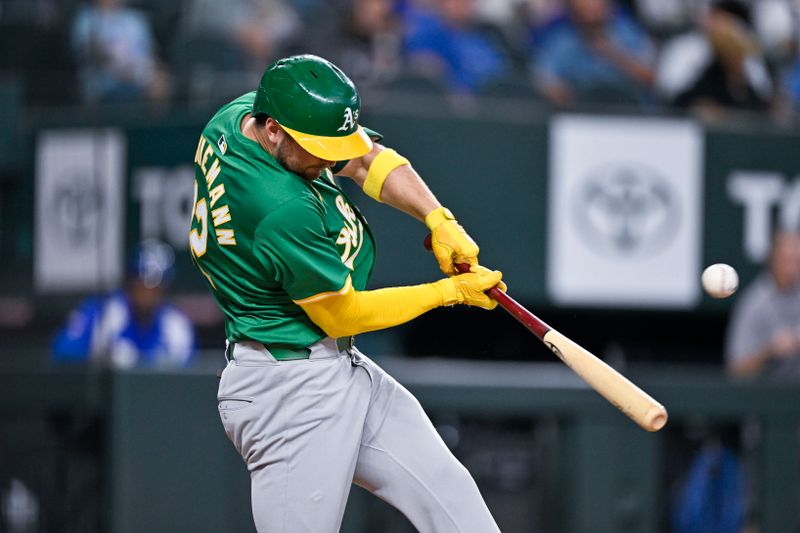 Sep 1, 2024; Arlington, Texas, USA; Oakland Athletics third baseman Max Schuemann (12) hits a single and drives in the tying run against the Texas Rangers during the eighth inning at Globe Life Field. Mandatory Credit: Jerome Miron-USA TODAY Sports