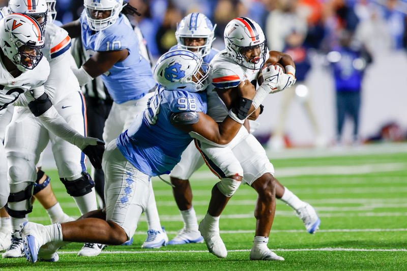 Oct 21, 2023; Chapel Hill, North Carolina, USA; Virginia Cavaliers running back Perris Jones (2) fights for yards as North Carolina Tar Heels defensive lineman Kevin Hester Jr. (98) makes the tackle in the second half at Kenan Memorial Stadium. Mandatory Credit: Nell Redmond-USA TODAY Sports