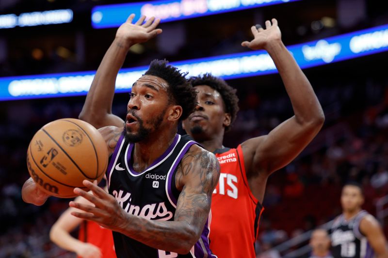 HOUSTON, TEXAS - NOVEMBER 06: Malik Monk #0 of the Sacramento Kings passes the ball ahead of Jae'Sean Tate #8 of the Houston Rockets during the first half at Toyota Center on November 06, 2023 in Houston, Texas. (Photo by Carmen Mandato/Getty Images)