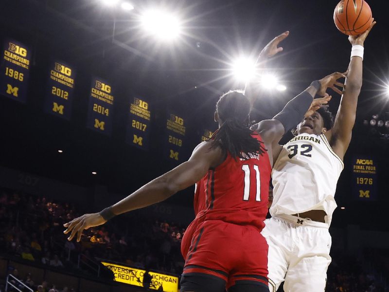 Feb 3, 2024; Ann Arbor, Michigan, USA;  Michigan Wolverines forward Tarris Reed Jr. (32) shoots on Rutgers Scarlet Knights center Clifford Omoruyi (11) in the first half at Crisler Center. Mandatory Credit: Rick Osentoski-USA TODAY Sports