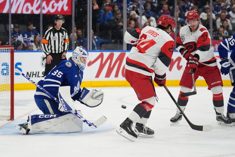 Nov 9, 2025; Toronto, Ontario, CAN; Toronto Maple Leafs goaltender Dennis Hildeby (35) goes to make a save on a puck tipped by Carolina Hurricanes forward Andrei Svechnikov (37) during the second period at Scotiabank Arena. Mandatory Credit: John E. Sokolowski-Imagn Images