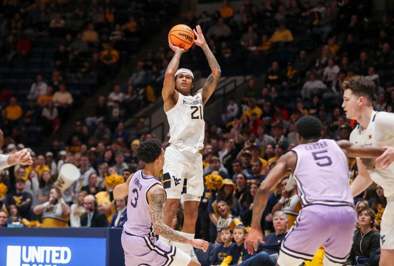 Jan 9, 2024; Morgantown, West Virginia, USA; West Virginia Mountaineers guard RaeQuan Battle (21) shoots a three pointer during the second half against the Kansas State Wildcats at WVU Coliseum. Mandatory Credit: Ben Queen-USA TODAY Sports