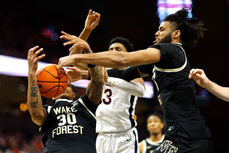 Feb 17, 2024; Charlottesville, Virginia, USA; Wake Forest Demon Deacons guard Damari Monsanto (30) and Demon Deacons forward Efton Reid III (4) reach for a rebound in front of Virginia Cavaliers guard Ryan Dunn (13) in the second half at John Paul Jones Arena. Mandatory Credit: Geoff Burke-USA TODAY Sports