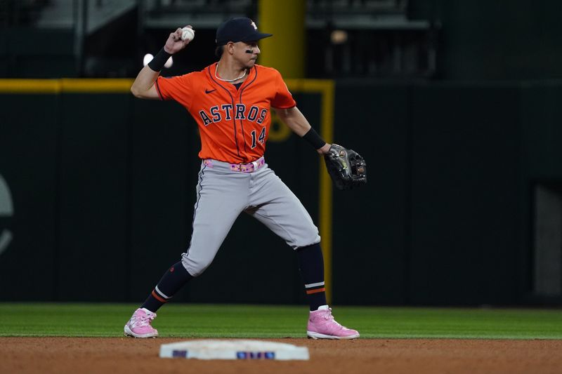 May 15, 2025; Arlington, Texas, USA; Houston Astros second baseman Mauricio Dubón (14) throws to first base during the eighth inning against the Texas Rangers at Globe Life Field. Mandatory Credit: Raymond Carlin III-Imagn Images