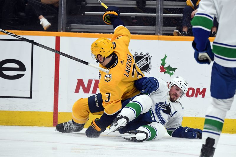 Dec 19, 2023; Nashville, Tennessee, USA; Nashville Predators defenseman Jeremy Lauzon (3) and Vancouver Canucks center J.T. Miller (9) fall to the ice going for a puck in the corner during the second period at Bridgestone Arena. Mandatory Credit: Christopher Hanewinckel-USA TODAY Sports