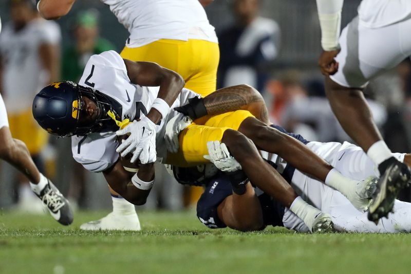 Sep 2, 2023; University Park, Pennsylvania, USA; West Virginia Mountaineers Traylon Ray (7) is tackled by Penn State Nittany Lions defensive tackle Dvon Ellies (91) during the fourth quarter at Beaver Stadium. Penn State won 38-15. Mandatory Credit: Matthew O'Haren-USA TODAY Sports