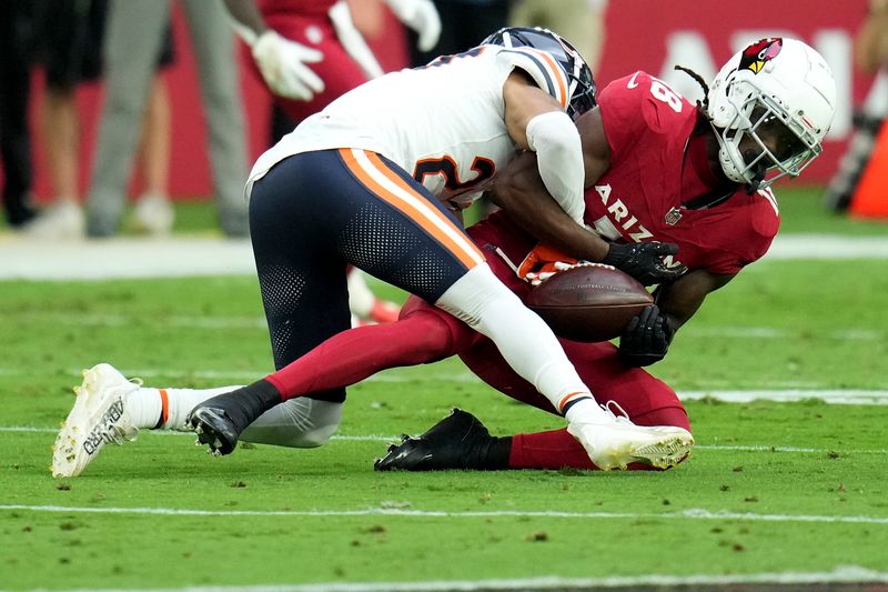 Arizona Cardinals wide receiver Marvin Harrison Jr. (18) fumbles the ball on a hit by Chicago Bears cornerback Reddy Steward during the first half of an NFL football game, Tuesday, Nov. 3, 2026, in Glendale, Ariz. (AP Photo/Ross D. Franklin)