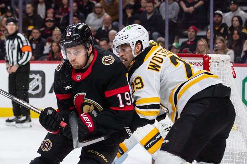 Jan 18, 2025; Ottawa, Ontario, CAN; Ottawa Senators right wing Drake Batherson (19) battles with Boston Bruins defenseman Parker Wotherspoon (29) in the first period at the Canadian Tire Centre. Mandatory Credit: Marc DesRosiers-Imagn Images