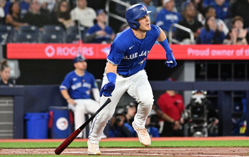 Apr 13, 2024; Toronto, Ontario, CAN;  Toronto Blue Jays center fielder Daulton Varsho (25) hits a grand slam home run against the Colorodo Rockies in the first inning at Rogers Centre. Mandatory Credit: Dan Hamilton-USA TODAY Sports